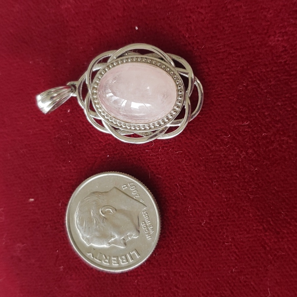 Pink pendant with silver detail.